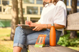 woman on bench writing